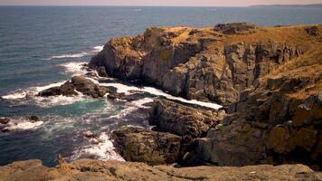 Storm at Black sea. Big waves break on the rocky shore, white foam on the water. Bulgaria video