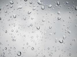 Rain and dew drop on the car glass window during raining. photo