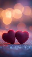 Two red velvet hearts on a glowing glitter surface, heart-shaped bokeh softly floating above, warm romantic tones of pink and purple photo