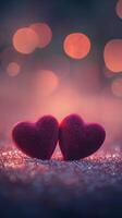 Two red velvet hearts on a glowing glitter surface, heart-shaped bokeh softly floating above, warm romantic tones of pink and purple photo