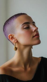 Close-up of a woman with purple buzzcut, wearing statement earrings, playful facial expression, in a minimalist studio setting with soft lighting photo