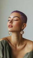 Close-up of a woman with purple buzzcut, wearing statement earrings, playful facial expression, in a minimalist studio setting with soft lighting photo