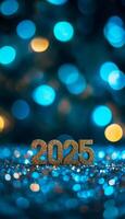 The number 2025 in golden font placed on a glittering, festive surface with blurred blue bokeh lights in the background photo