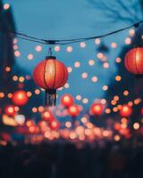 Festive red lanterns glowing above a busy street, softly lit with blurred crowds in the background, celebrating a festival photo