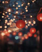 Hanging red lanterns glowing against a night sky, surrounded by bokeh lights and blurred figures celebrating a festival photo