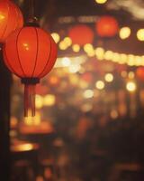 Vibrant red lanterns swaying gently, surrounded by blurry lights and a festive crowd in the background, glowing softly under warm lighting photo