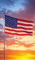 American flag flying vertically with a dramatic sunset sky in the background, vivid colors and texture details photo