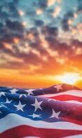 Close-up of American flag fabric with stars and stripes, vertical composition, sunset sky in the background photo