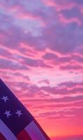 Close-up of American flag fabric in vertical frame, with a soft pink and purple sunset sky photo