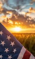 Close-up of American flag fabric with stars and stripes, vertical composition, sunset sky in the background photo