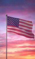 Waving American flag in vertical format, dramatic sunset sky in the background, vibrant stars and stripes photo