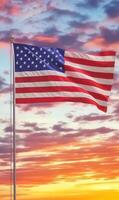 Waving American flag in vertical format, dramatic sunset sky in the background, vibrant stars and stripes photo