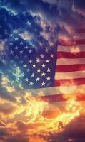 Vertical shot of the American flag, stars in focus with sunset-lit clouds in the background photo