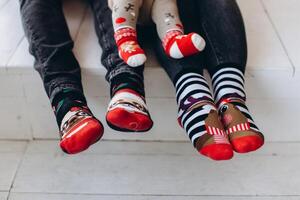 Fragment of a leg in Christmas socks, three, family, copy space photo