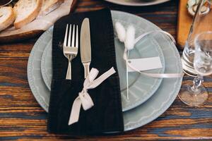 Close up of serving set, plate fork and knife decorated with decor on wooden table for your mockup photo