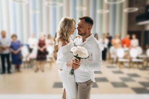 Romantic Wedding Ceremony Couple Embracing with Guests in Background photo