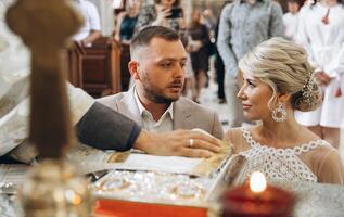 The groom takes an oath to the bride during the wedding ceremony in the church. photo