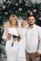 Joyful Couple Celebrating Their Engagement with Smiles and Rings in a Romantic Setting photo