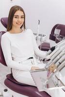 The girl's visit to the dentist. The girl is sitting on a dental chair. photo