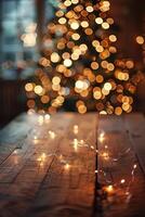 Wooden Tabletop with String Lights and Blurred Christmas Tree Lights in Background photo