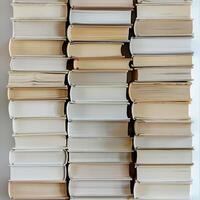 Aged and Worn Stack of Hardcover Books in Dark Setting photo