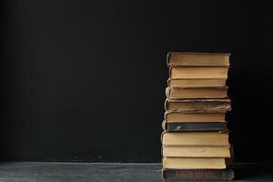 Rustic Pile of Hardcover Books on a Dark Background photo