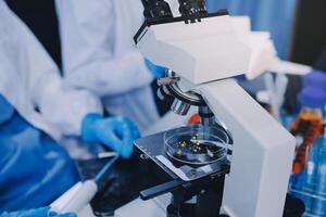 Scientist using microscope in laboratory. Close-up of a researcher's hands adjusting a modern microscope in a lab setting. Science concept photo