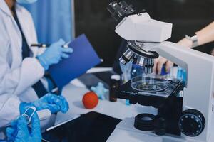 Scientist using microscope in laboratory. Close-up of a researcher's hands adjusting a modern microscope in a lab setting. Science concept photo