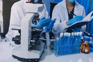 Scientist using microscope in laboratory. Close-up of a researcher's hands adjusting a modern microscope in a lab setting. Science concept photo