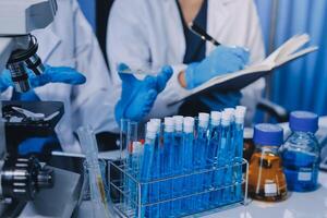 Scientist using microscope in laboratory. Close-up of a researcher's hands adjusting a modern microscope in a lab setting. Science concept photo