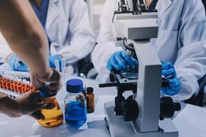 Scientist using microscope in laboratory. Close-up of a researcher's hands adjusting a modern microscope in a lab setting. Science concept photo