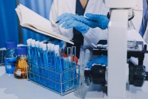 Scientist using microscope in laboratory. Close-up of a researcher's hands adjusting a modern microscope in a lab setting. Science concept photo