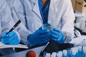 Scientist using microscope in laboratory. Close-up of a researcher's hands adjusting a modern microscope in a lab setting. Science concept photo