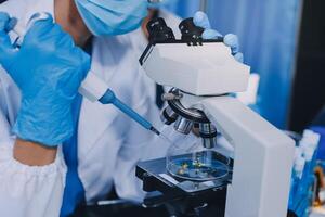 Scientist using microscope in laboratory. Close-up of a researcher's hands adjusting a modern microscope in a lab setting. Science concept photo