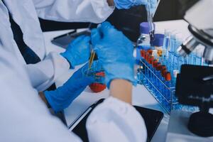 Scientist using microscope in laboratory. Close-up of a researcher's hands adjusting a modern microscope in a lab setting. Science concept photo