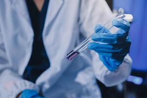 Scientist using microscope in laboratory. Close-up of a researcher's hands adjusting a modern microscope in a lab setting. Science concept photo