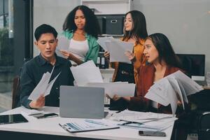 Stress, business people and employee frustrated with multitasking, pressure or overworked by team in chaos with paperwork. Anxiety, headache and worker overwhelmed by group and burnout in crisis photo