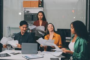 Stress, business people and employee frustrated with multitasking, pressure or overworked by team in chaos with paperwork. Anxiety, headache and worker overwhelmed by group and burnout in crisis photo