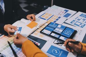 The designer team is designing the uxui system to make the uxui system work well on new phones and support system updates. Website development concept UI UX front end designer photo