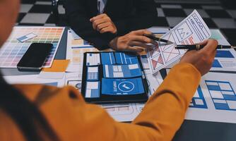 The designer team is designing the uxui system to make the uxui system work well on new phones and support system updates. Website development concept UI UX front end designer photo