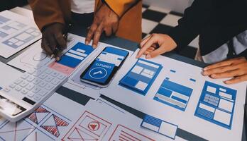 The designer team is designing the uxui system to make the uxui system work well on new phones and support system updates. Website development concept UI UX front end designer photo