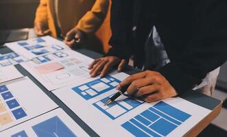 The designer team is designing the uxui system to make the uxui system work well on new phones and support system updates. Website development concept UI UX front end designer photo