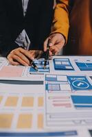 The designer team is designing the uxui system to make the uxui system work well on new phones and support system updates. Website development concept UI UX front end designer photo