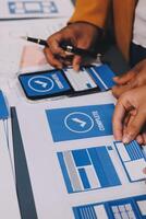 The designer team is designing the uxui system to make the uxui system work well on new phones and support system updates. Website development concept UI UX front end designer photo