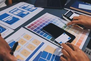 The designer team is designing the uxui system to make the uxui system work well on new phones and support system updates. Website development concept UI UX front end designer photo