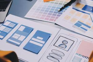 The designer team is designing the uxui system to make the uxui system work well on new phones and support system updates. Website development concept UI UX front end designer photo