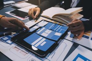 The designer team is designing the uxui system to make the uxui system work well on new phones and support system updates. Website development concept UI UX front end designer photo