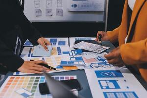 The designer team is designing the uxui system to make the uxui system work well on new phones and support system updates. Website development concept UI UX front end designer photo