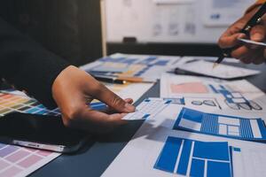 The designer team is designing the uxui system to make the uxui system work well on new phones and support system updates. Website development concept UI UX front end designer photo