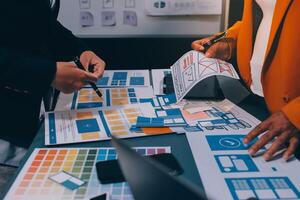 The designer team is designing the uxui system to make the uxui system work well on new phones and support system updates. Website development concept UI UX front end designer photo